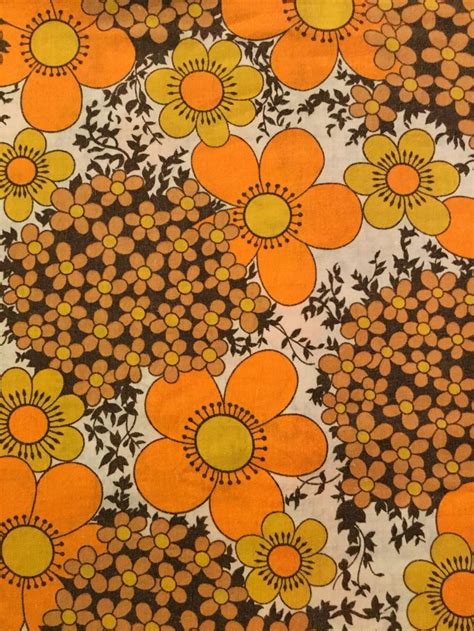 an orange and black flower pattern on fabric