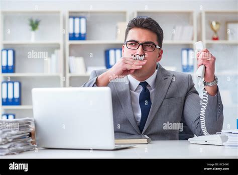 Businessman Smoking In Office At Work Stock Photo Alamy