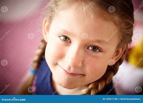 Close Up Of A Smiling Beautiful Baby Girl With Green Eyes Stock Photo