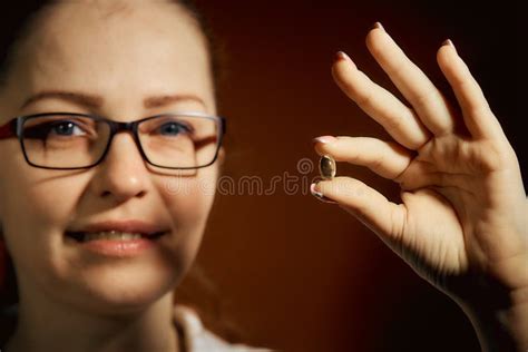 Woman Holding A Pill In Her Hand Treatment Of Colds Stock Image