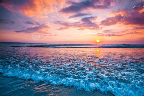 Sunset Over Ocean Splashing Ocean Wave In Front Of Beautiful Sunset Sky