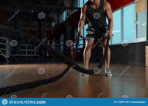 Man Working Out With Battle Ropes In Modern Gym Stock Photo Image Of