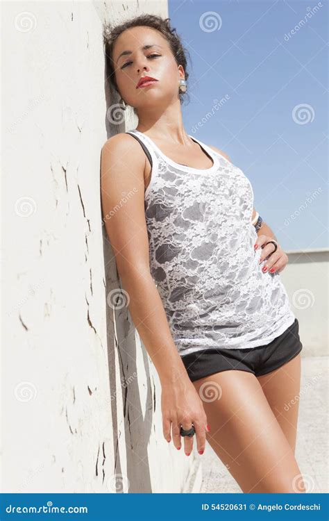 Sensual Brunette Tanned Girl Leaning On A Wall Hot Sun Stock Photo