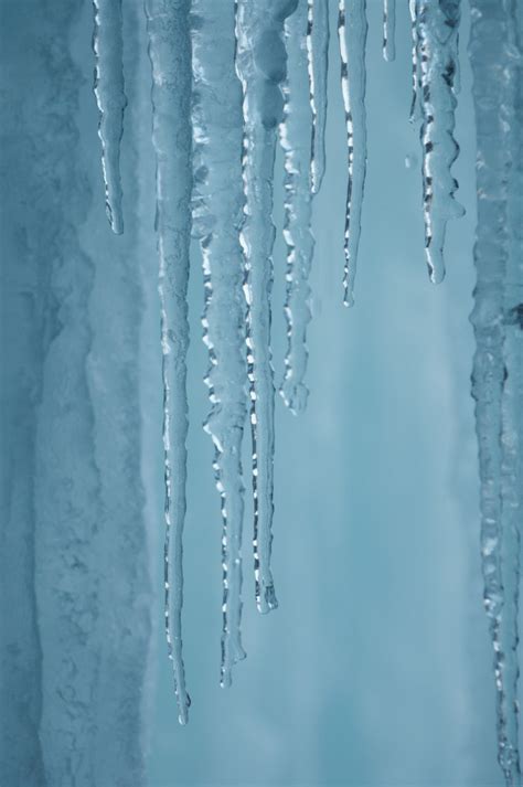 Premium Photo A Frozen Waterfall With Ice In A Blue And White Color