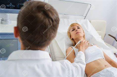 The Lady Pacient At Ultrasonography Examination At The Neck Stock Photo