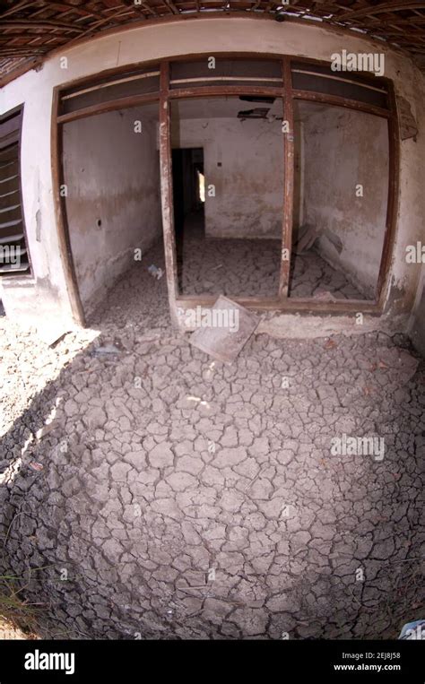 abandoned house with dried mud on floor following flooding by mud lake environmental disaster