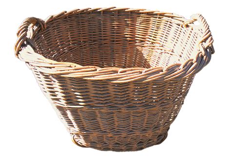 A container made of interwoven strips of pliable materials, such as cane, straw, thin wood, or plastic, and often carried by means of a handle or handles 2. Vintage French Gathering Basket | Omero Home