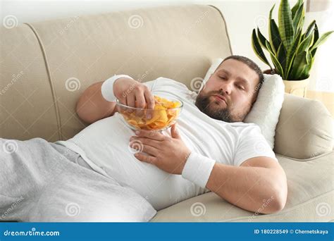 Lazy Overweight Man Eating Chips On Sofa Stock Image Image Of Resting