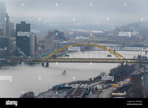 A towboat navigates through the fog on the Monongahela River in