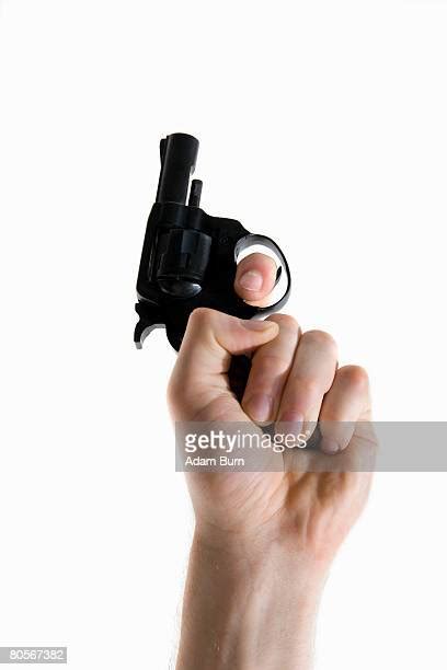 Hand Holding Gun Close Up Low Angle View Photos And Premium High Res