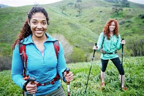 Portrait Of Smiling Women Hiking With Walking Sticks Stock Photo