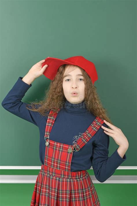 Schoolgirl Near Green School Board Young Playful Girl Holds A Red Cap Stock Image Image Of