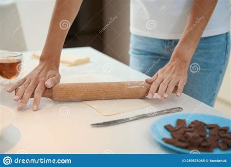 Woman Rolling Out Sheet Of Dough Using A Rolling Pin Stock Image