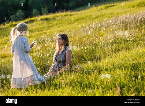 Pregnant Mother And Daughter On A Meadow Stock Photo Alamy