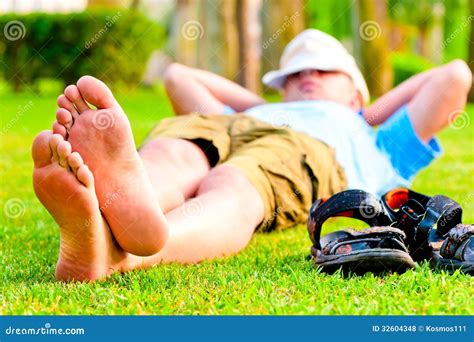 Barefoot Man Is Resting On Green Grass Stock Photo Image Of Concepts