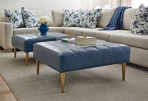 It will definitely captivate anyone who sees it. Blue leather ottoman sit on a gray rug in a gray and blue ...