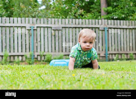 Cute Baby Crawling In The Grass Stock Photo Alamy