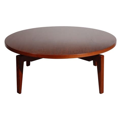 The four sculpted legs of the base are slightly splayed. Jens Risom Coffee Table with Revolving Top at 1stdibs