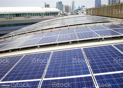 Rooftop Solar Panels On Factory Roof Stock Photo