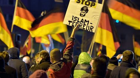 A Protester In Germany Holds A Banner Reading Stop Islam Terror During A Rally By A Group