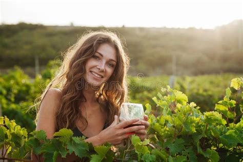 Beautiful Woman With A Glass Of Wine In The Vineyard Stock Photo
