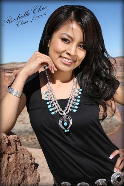 A Woman Wearing A Necklace And Bracelet Posing For The Camera With Her Hand On Her Hip