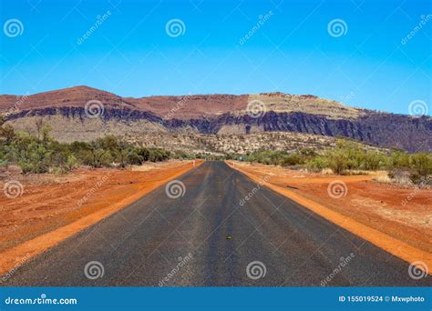 Freshly Paved Road Still Under Construction Filled With Stripped Red