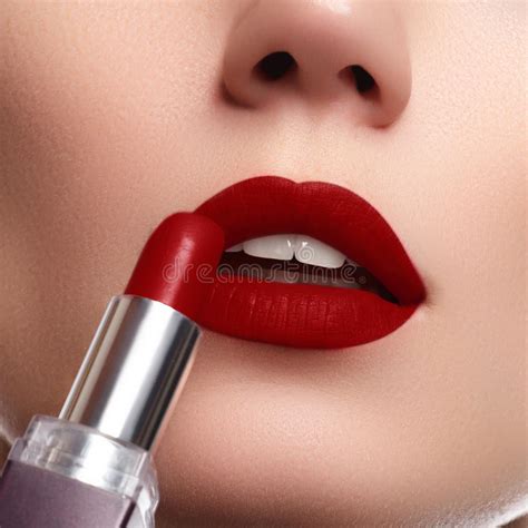 Extreme Close Up On Model Applying Dark Red Lipstick Makeup Stock