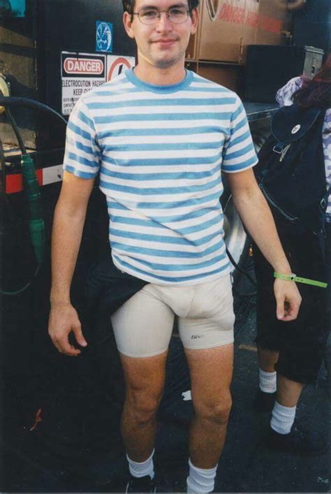 A Man In Shorts And A Striped Shirt