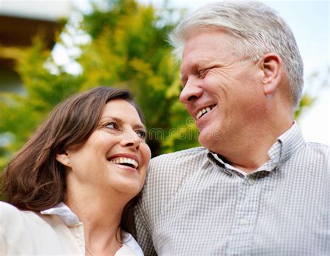 the secret to their happy marriage is love and laughter an affectionate senior couple standing