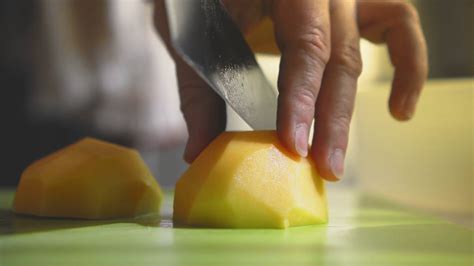 Closeup Of Hand With Knife Cutting Fresh Vegetable Woman Cutting