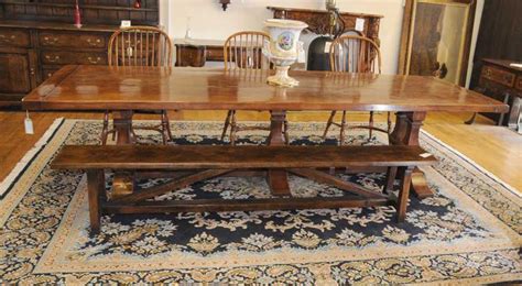 Crafted from solid and manufactured wood, it features a rustic and neutral finish perfect for traditional and modern farmhouse aesthetics alike. Norfolk Farmhouse Refectory Trestle Table Bench Set
