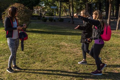 Three Young Women Meet In The Park They Greet Each Other And Are Happy