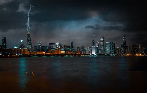 Photo Of Chicago Cityscape At Night While Lightning Strikes High Rise