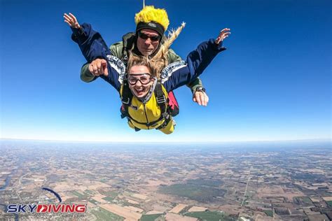 Woman Smiling In Freefall Tandem Skydive After Jumping From A Plane At