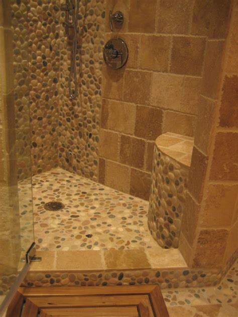 A natural stone tile bathroom is an elegant addition to any home. Island Stone pebble bathroom design - Rustic - Wall And ...