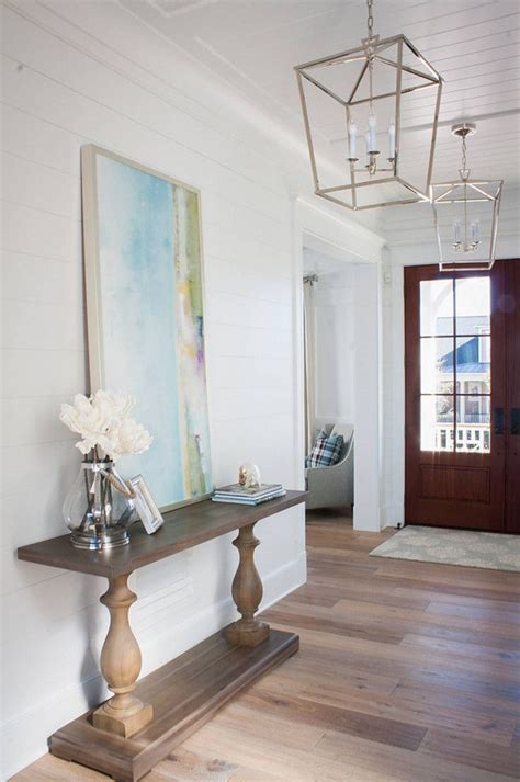In this unique home foyer, an industrial entryway table with black metal legs and a slender the light colouration of its surfaces both absorbs and reflects light, brightening the surrounding. Pin on Entryway