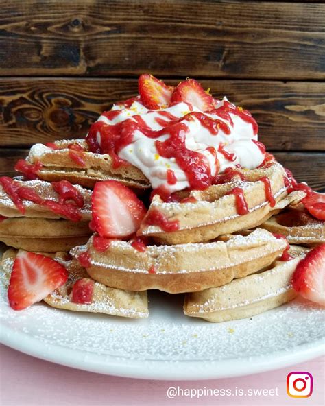 Homemade Waffles Topped With Strawberries Sauce And Whipped Cream