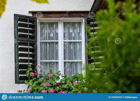 Open Window On The Facade Of A White Local Traditional Old House