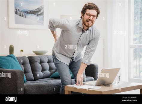 Painful Guy Aching From Pain In Back Or Reins At Home Stock Photo Alamy