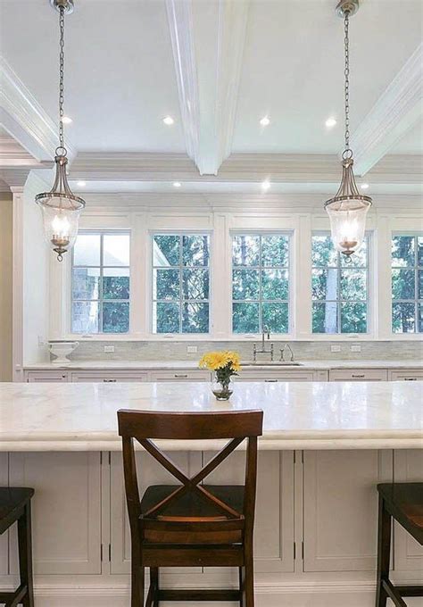 Here are 3 ways you can incorporate beautiful lighting into your coffered ceiling. White kitchen coffered ceiling. Cream cabinets & marble ...