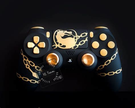 A Black Controller With Gold Chains On It