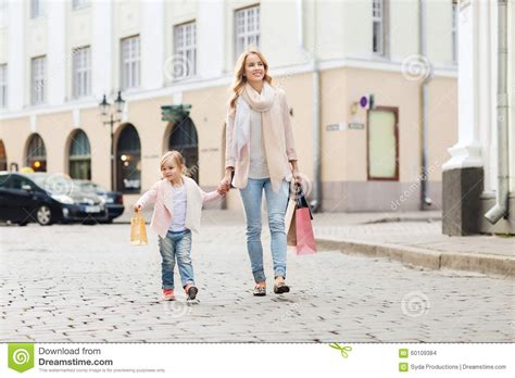 Happy Mother And Child With Shopping Bags In City Stock