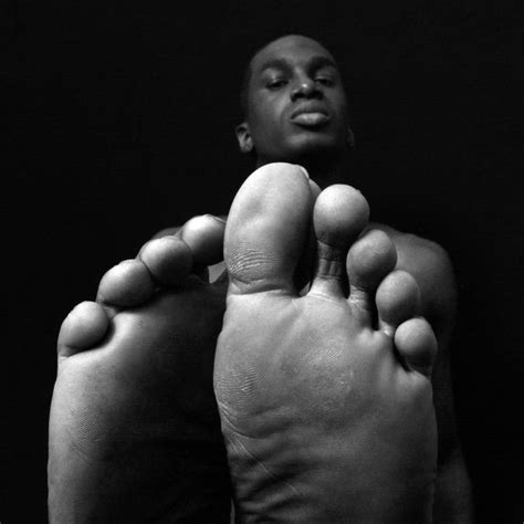 A Black And White Photo Of A Person S Feet With Their Toes Raised Up
