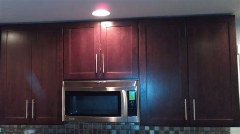 After picture of kitchen cabinets changed to bright white and island refinished in fired earth warm black. Kitchen cabinets: crown molding or flush with ceiling ...