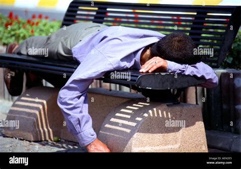 Sleeping Man On Park Bench Stock Photo Alamy