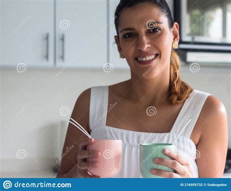 Latina Woman Showing Two Homemade Candles She Faces The Camera And