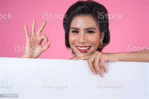 Portrait Of Fashion Woman Displaying White Banner Stock Photo