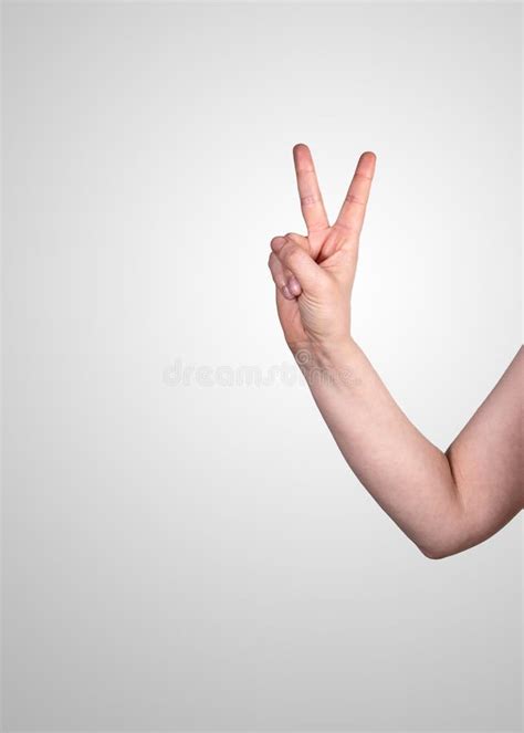 Victory Or Gesture Of Freedom Womans Hand On A Gray Backgroundpolicy