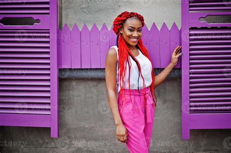 fashionable african american girl at pink pants and red dreads posed outdoor 10488304 stock